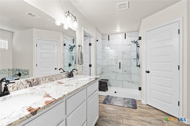 bathroom featuring an enclosed shower, hardwood / wood-style floors, and vanity