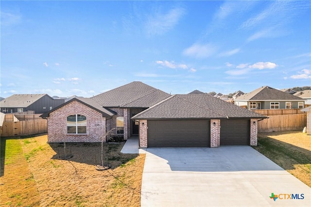 view of front of home featuring a garage and a front yard