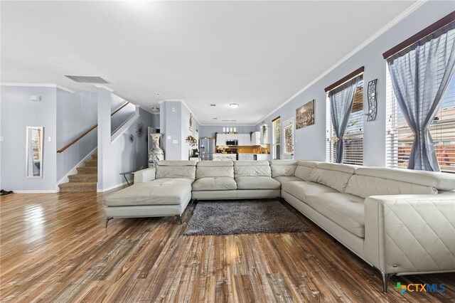 living room with hardwood / wood-style floors and ornamental molding