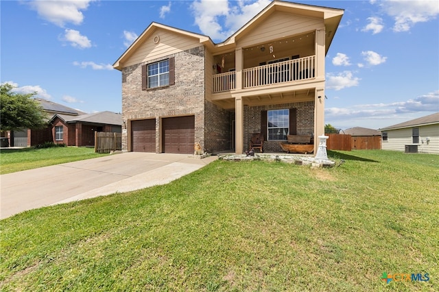 view of front of property with a balcony, a garage, and a front yard