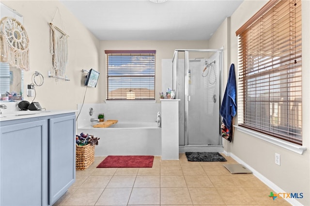 bathroom featuring plus walk in shower, tile patterned flooring, and vanity