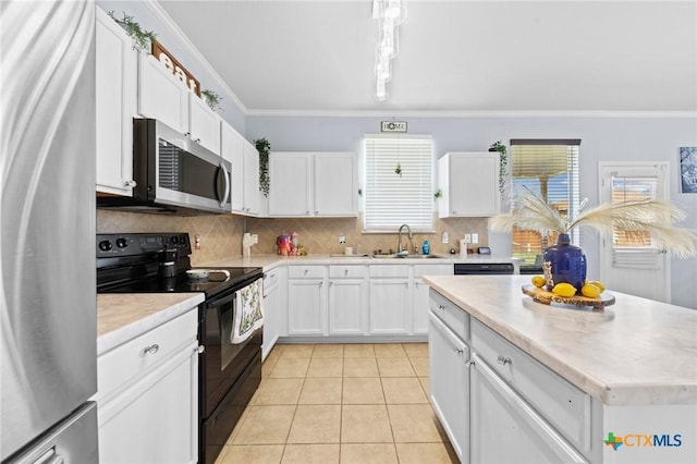 413 E Orion Dr, Killeen, TX 76542 - kitchen featuring stainless steel appliances, a sink, ornamental molding, tasteful backsplash, and white cabinets