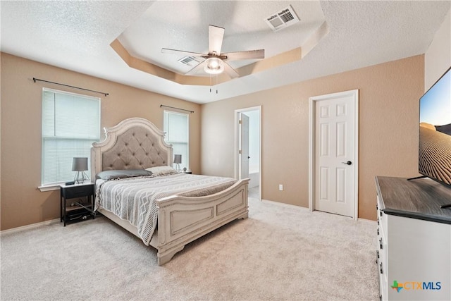 2606 Wesley Dr, Killeen, TX 76549 - bedroom with a raised ceiling, light carpet, a textured ceiling, and ceiling fan
