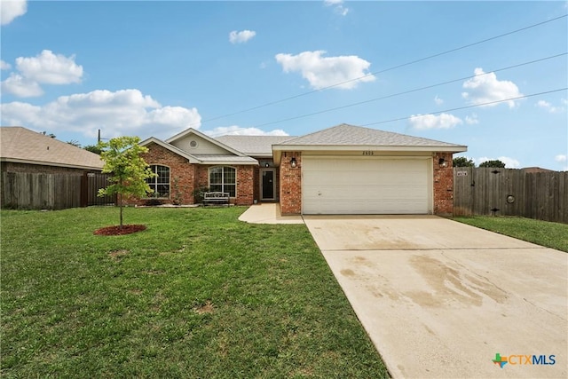 2606 Wesley Dr, Killeen, TX 76549 - ranch-style house with brick siding, an attached garage, and concrete driveway