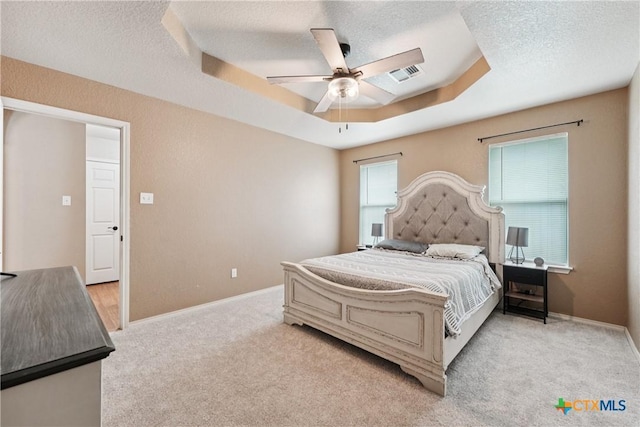 2606 Wesley Dr, Killeen, TX 76549 - bedroom featuring a tray ceiling, light colored carpet, a textured ceiling, and ceiling fan
