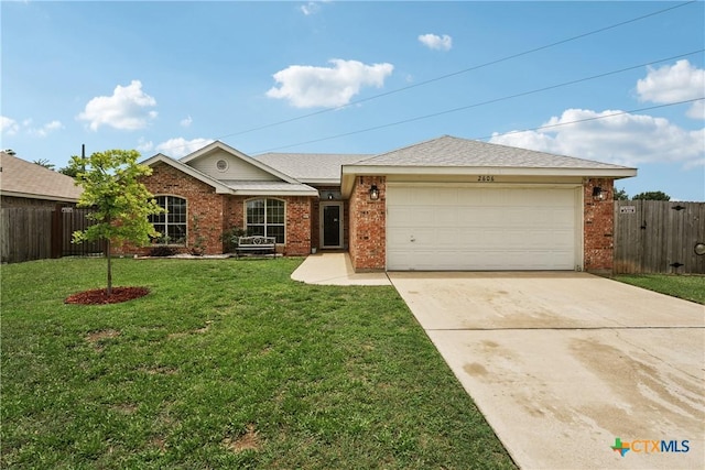 2606 Wesley Dr, Killeen, TX 76549 - single story home featuring brick siding, a garage, concrete driveway, and a shingled roof