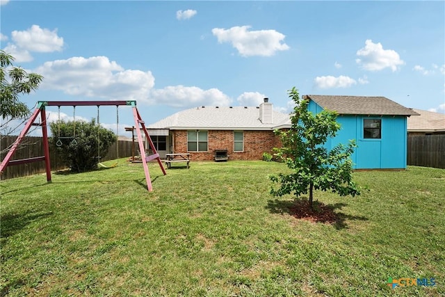 2606 Wesley Dr, Killeen, TX 76549 - rear view of property with a fenced backyard, a storage shed, a chimney, a playground, and brick siding