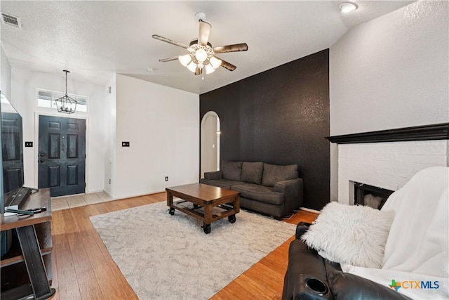 2606 Wesley Dr, Killeen, TX 76549 - living area with a ceiling fan, light wood-type flooring, arched walkways, and a fireplace