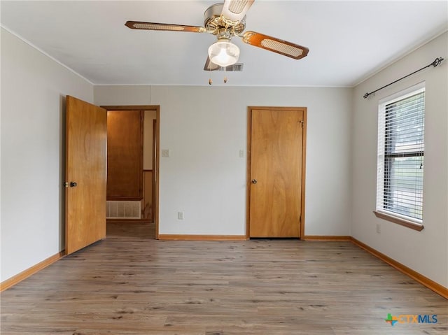 unfurnished bedroom featuring visible vents and light wood-style flooring