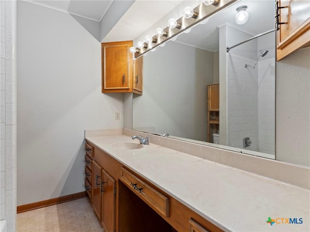 bathroom with vanity, shower / bathtub combination, and baseboards