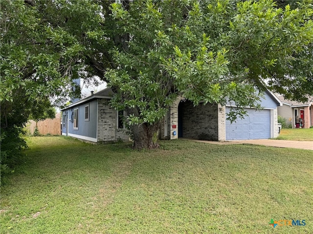 view of front of property featuring a garage and a front yard