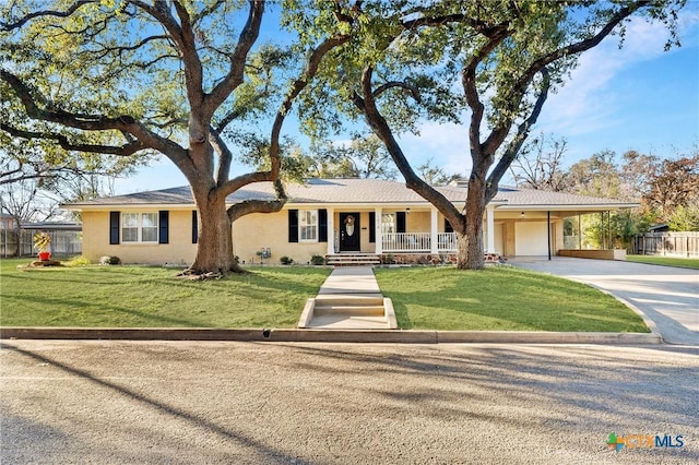 single story home featuring a front lawn, a carport, and a porch