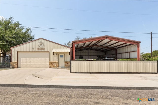 view of front of house featuring a garage and a carport