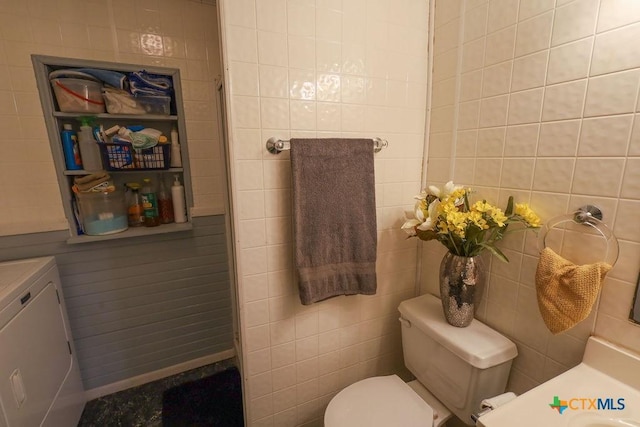 bathroom with tile walls and toilet