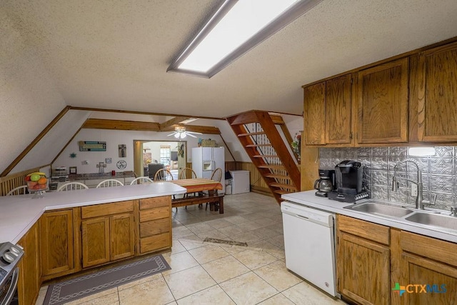 kitchen with white appliances, light tile patterned floors, ceiling fan, a textured ceiling, and sink