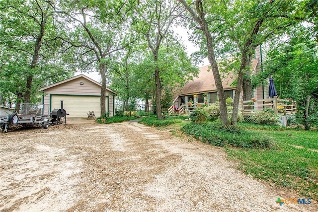 view of front facade with a garage and an outbuilding