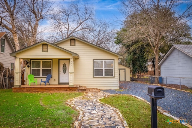 bungalow-style house with covered porch and a front yard