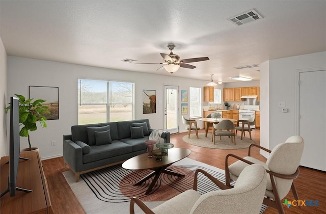 living room with ceiling fan, a healthy amount of sunlight, and dark hardwood / wood-style floors