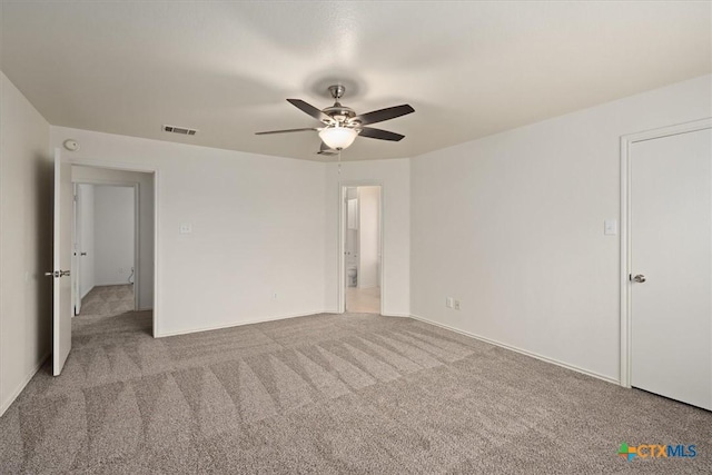 empty room featuring light colored carpet and ceiling fan