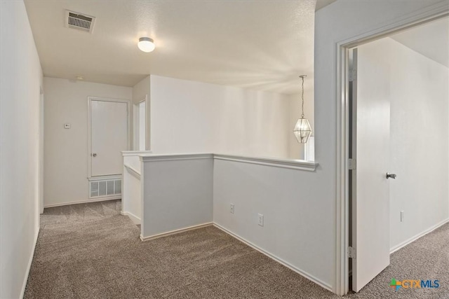 hallway with carpet floors