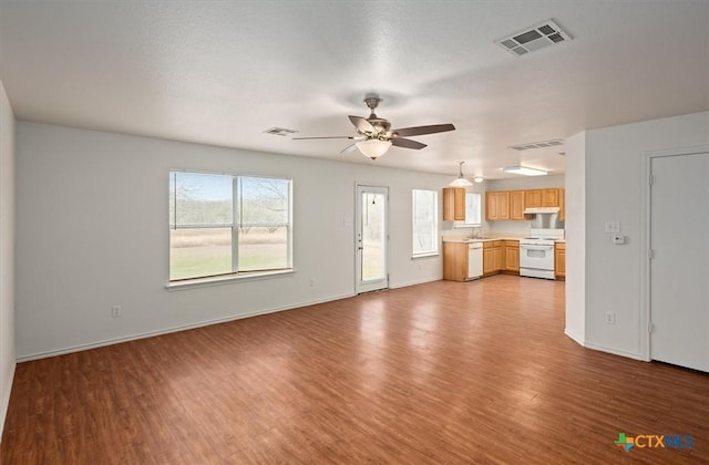 unfurnished living room with ceiling fan and light wood-type flooring