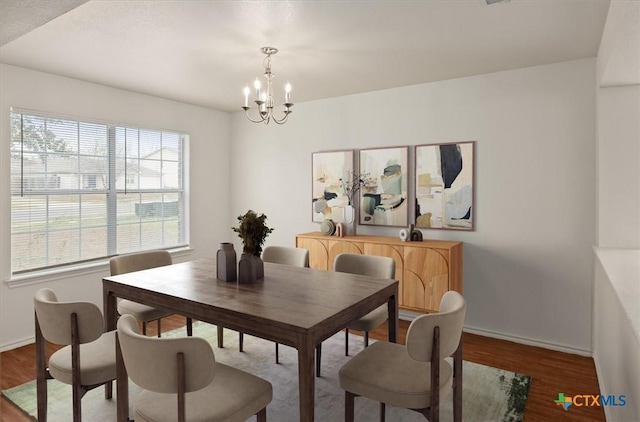 dining area featuring an inviting chandelier, a wealth of natural light, and wood-type flooring