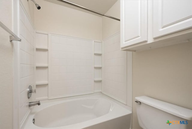 bathroom featuring tub / shower combination and toilet