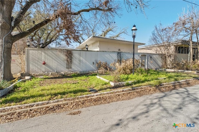 view of property exterior with fence