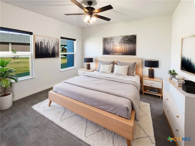 bedroom featuring dark colored carpet and ceiling fan