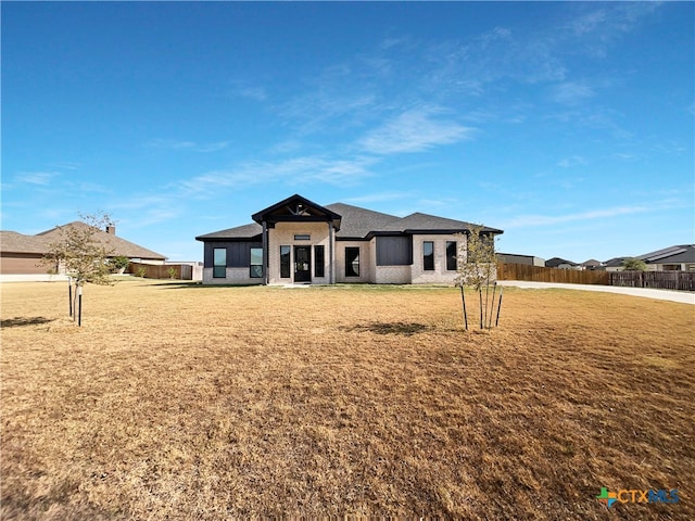 prairie-style house with a front lawn