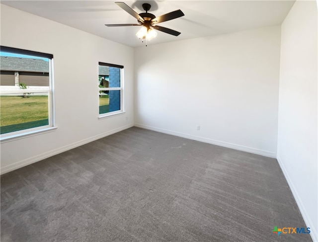 unfurnished room featuring ceiling fan and dark colored carpet