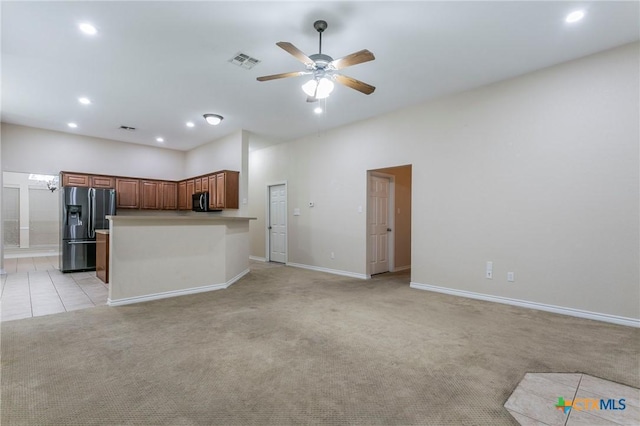 kitchen featuring light colored carpet, visible vents, brown cabinetry, open floor plan, and refrigerator with ice dispenser