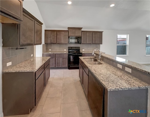 kitchen featuring light tile patterned flooring, sink, black appliances, dark brown cabinets, and lofted ceiling