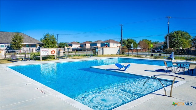 pool featuring a patio area and fence