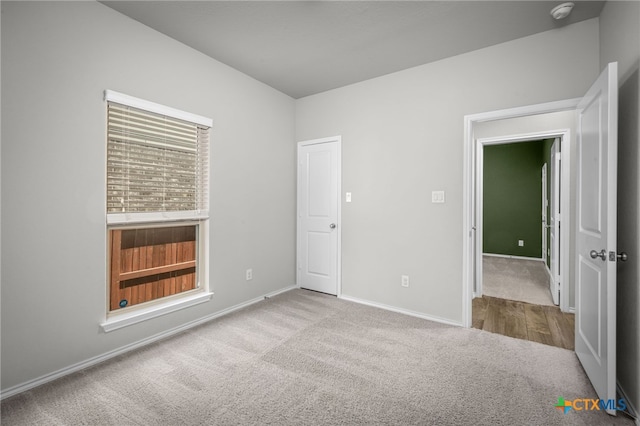 unfurnished bedroom featuring baseboards and carpet floors