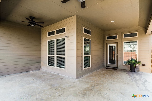 entrance to property featuring a ceiling fan and a patio area