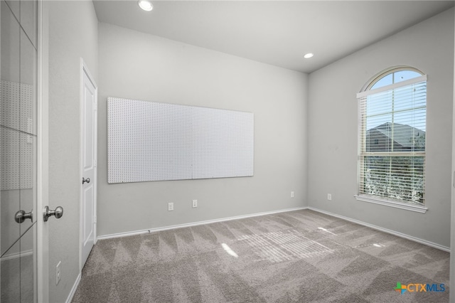 empty room with recessed lighting, baseboards, and carpet floors