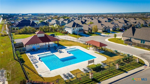 community pool featuring a gazebo, a residential view, a patio area, and fence