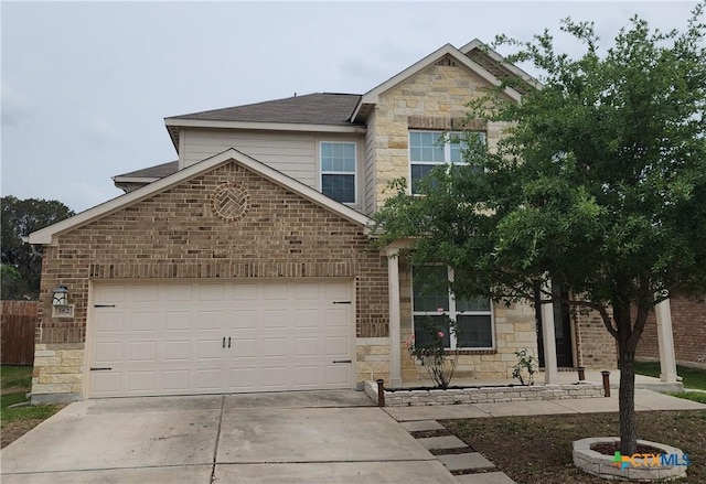view of front of house with concrete driveway, an attached garage, brick siding, and stone siding