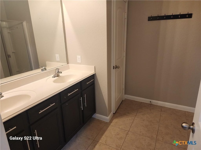 362 Azalea Way, New Braunfels, TX 78132 - bathroom featuring double vanity, baseboards, and tile patterned floors