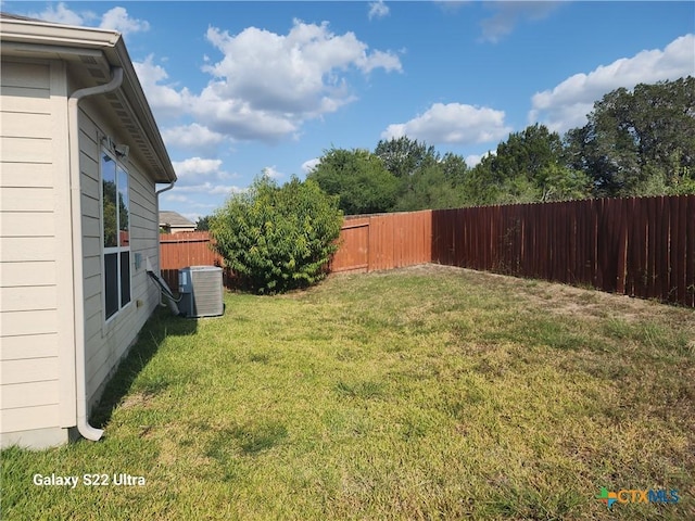 view of yard featuring a fenced backyard and central AC unit