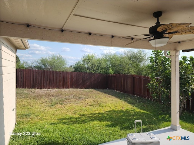 view of yard with ceiling fan and a fenced backyard