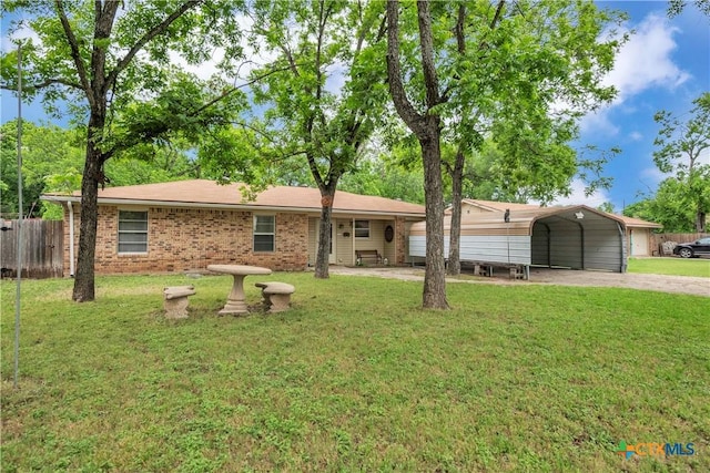single story home featuring a detached carport, driveway, and a front lawn