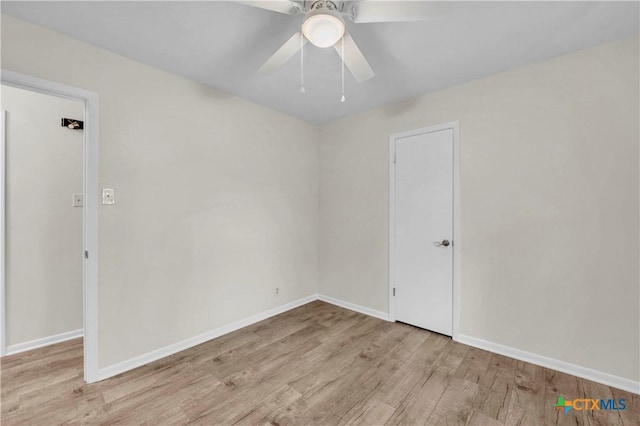 unfurnished room with baseboards, a ceiling fan, and wood finished floors