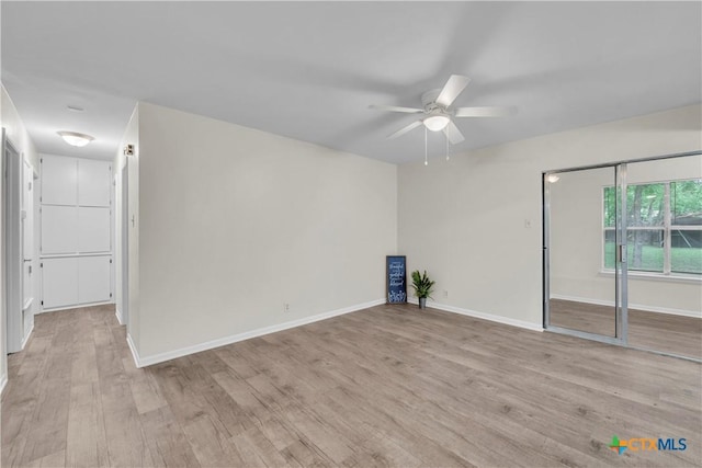 unfurnished room with baseboards, a ceiling fan, and light wood finished floors