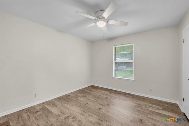 empty room with baseboards, a ceiling fan, and wood finished floors