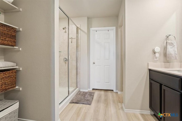 8812 Cantera Ridge Rd, Temple, TX 76502 - bathroom featuring a stall shower, wood finished floors, vanity, and baseboards