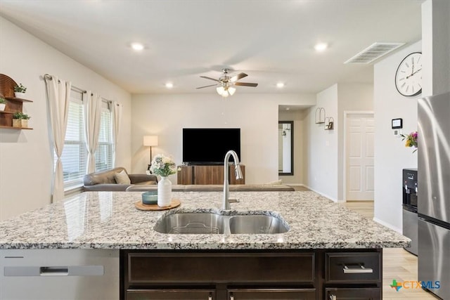 8812 Cantera Ridge Rd, Temple, TX 76502 - kitchen featuring a sink, open floor plan, ceiling fan, stainless steel appliances, and light wood finished floors