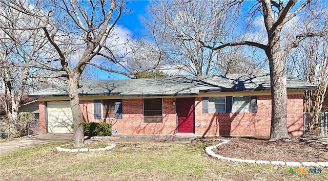 ranch-style house with an attached garage, driveway, a front lawn, and brick siding