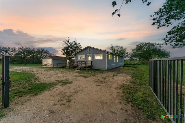 1236 County Road 7611, Devine, TX 78016 - view of property exterior with dirt driveway and an outbuilding